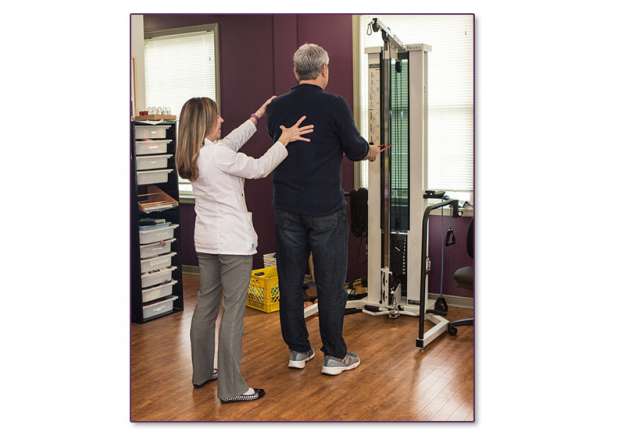 Linda Stanley, assisting a patient, with an upper shoulder issue.